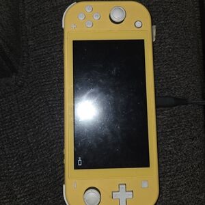 Yellow Handheld Gaming Nintendo Switch with White Accents
